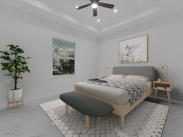 bedroom featuring a raised ceiling and ceiling fan