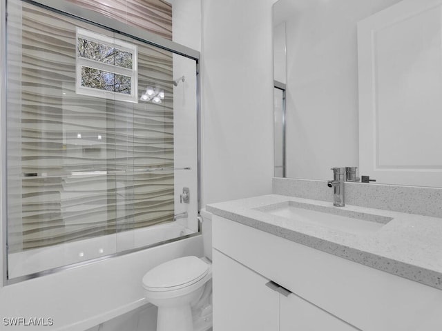 full bathroom with shower / bath combination with glass door, vanity, and toilet