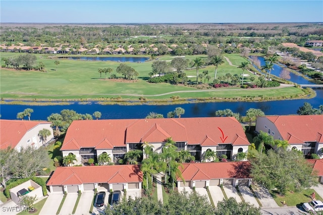 aerial view featuring a residential view, a water view, and view of golf course