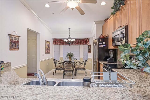 kitchen with ceiling fan with notable chandelier, appliances with stainless steel finishes, decorative light fixtures, and crown molding