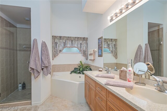 bathroom with tile patterned floors, separate shower and tub, and vanity