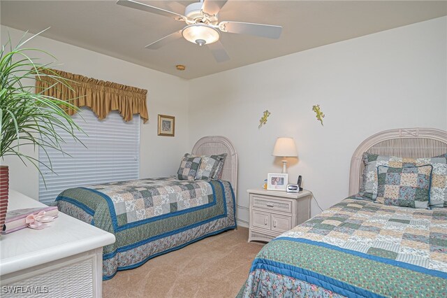 bedroom featuring ceiling fan and light colored carpet