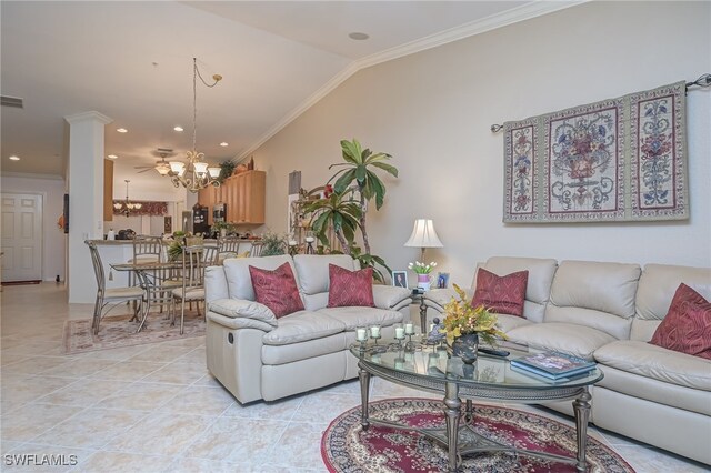 tiled living room featuring crown molding, vaulted ceiling, an inviting chandelier, and ornate columns