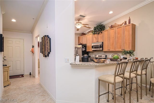 kitchen featuring appliances with stainless steel finishes, light tile patterned floors, ceiling fan, and ornamental molding