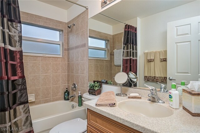 full bathroom with toilet, shower / tub combo, and vanity