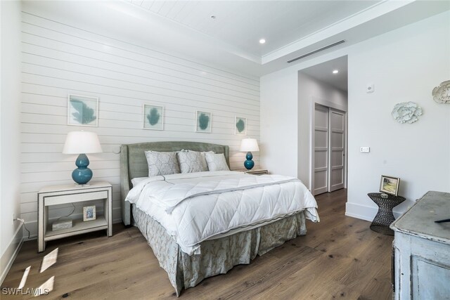 bedroom featuring dark hardwood / wood-style floors and a raised ceiling