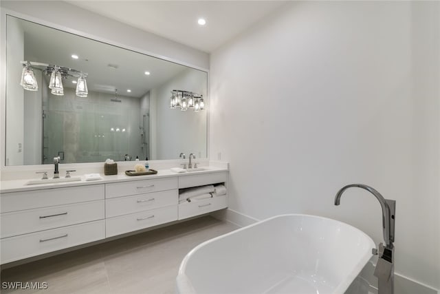 full bathroom featuring a stall shower, a soaking tub, a sink, and double vanity