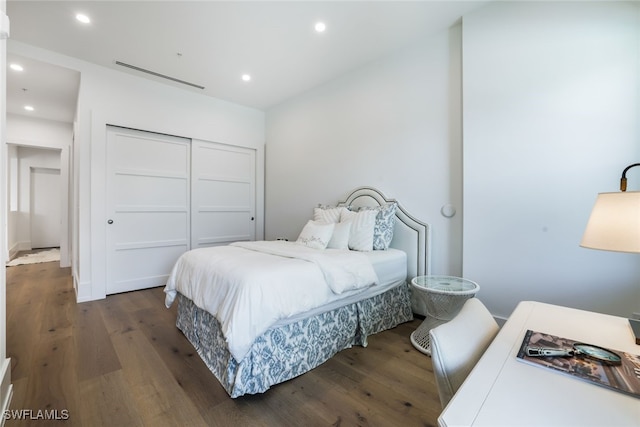 bedroom featuring a closet and dark wood-type flooring