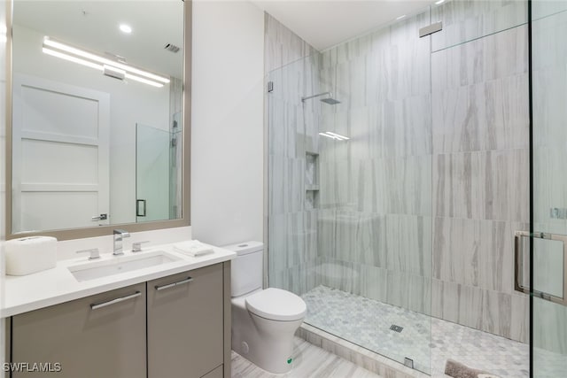 full bathroom featuring visible vents, vanity, a shower stall, and toilet