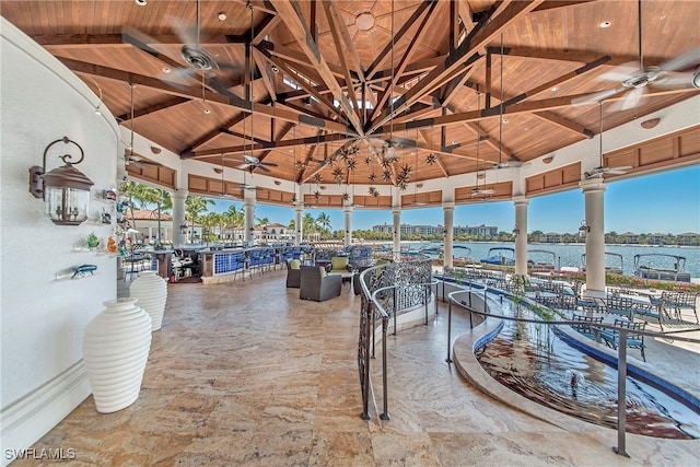 view of patio featuring ceiling fan, a gazebo, and a water view