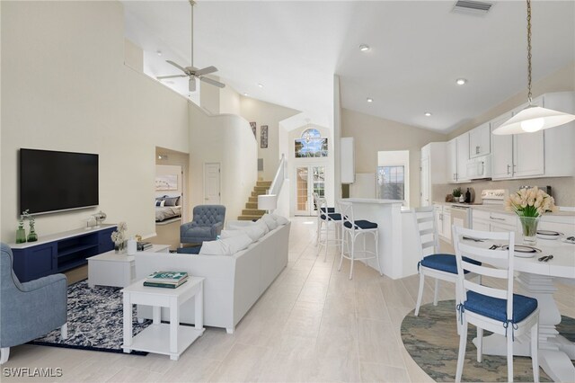 living room featuring visible vents, stairs, recessed lighting, high vaulted ceiling, and a ceiling fan