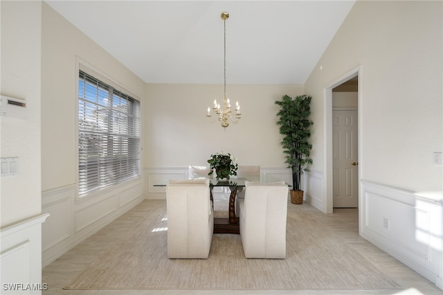 unfurnished dining area with a chandelier and vaulted ceiling