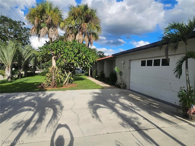 view of home's exterior with a lawn and a garage