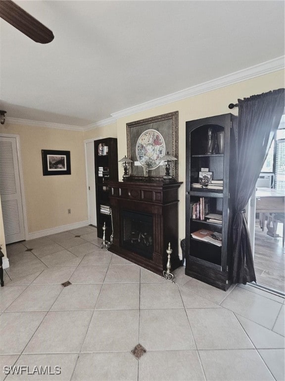 living room featuring ornamental molding, light tile patterned floors, and ceiling fan