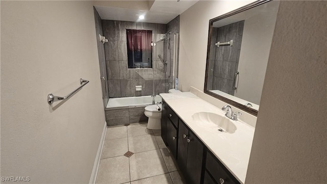 full bath with toilet, tiled shower / bath combo, vanity, baseboards, and tile patterned floors