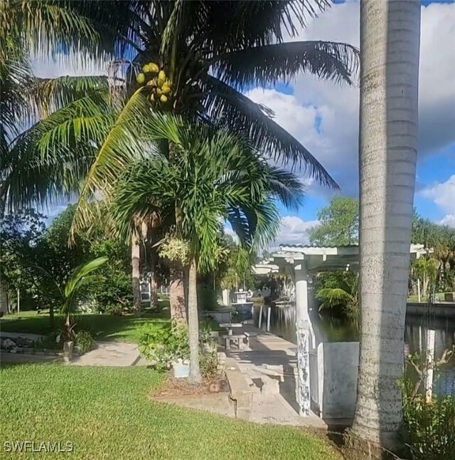 exterior space featuring a water view and a lawn