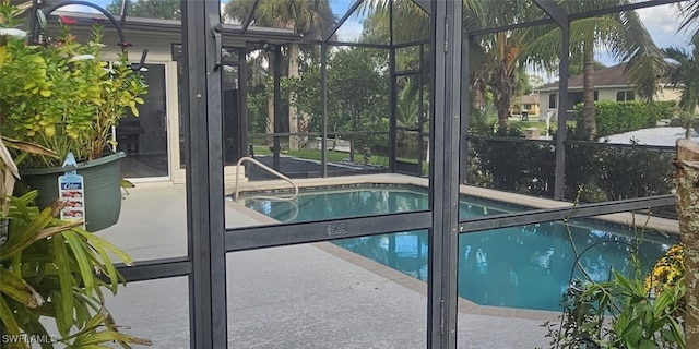 view of pool featuring a lanai and a patio