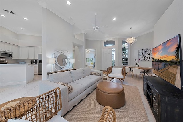 living room with ornamental molding, light tile patterned floors, and ceiling fan