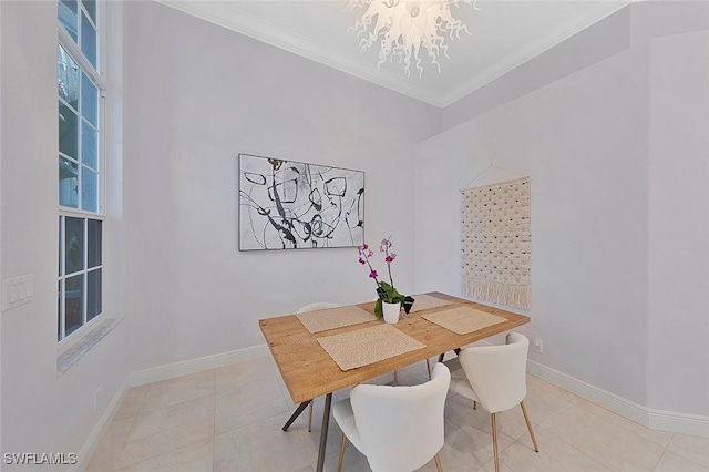 dining area featuring a chandelier, ornamental molding, light tile patterned floors, and baseboards