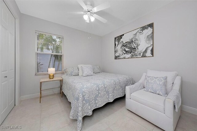 bedroom featuring ceiling fan, a closet, and light tile patterned flooring