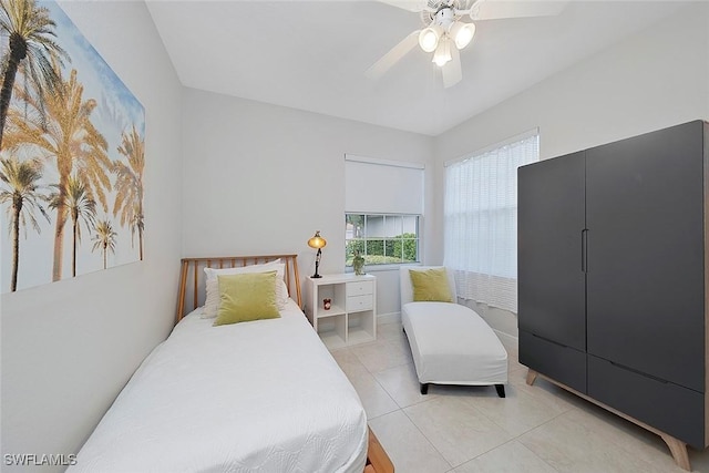 bedroom with light tile patterned floors and ceiling fan