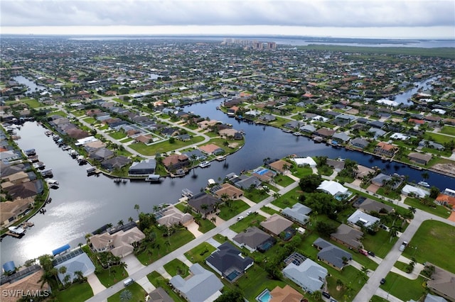 birds eye view of property featuring a water view and a residential view