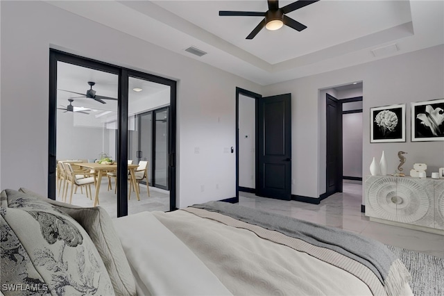 bedroom with access to exterior, a raised ceiling, visible vents, and baseboards