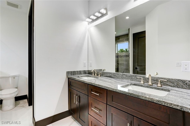 bathroom with toilet, a sink, visible vents, and a shower stall