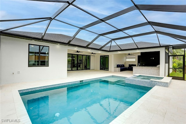 view of pool with a pool with connected hot tub, a ceiling fan, a patio area, a lanai, and an outdoor living space