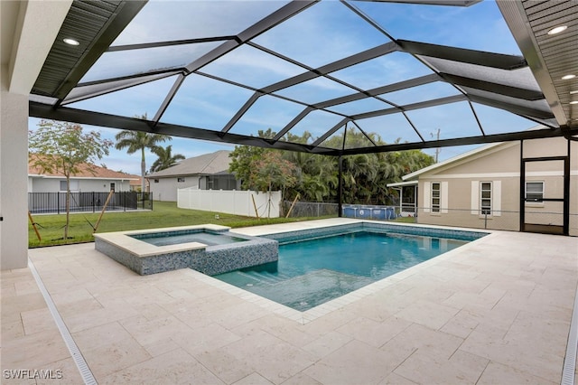 view of swimming pool with a pool with connected hot tub, a lawn, a patio, and fence