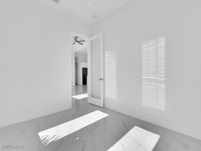 spare room featuring ceiling fan and french doors