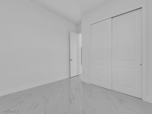 unfurnished bedroom with a closet