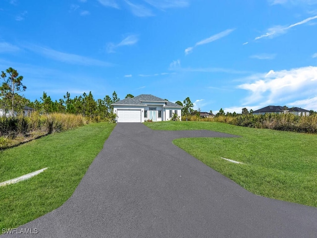 single story home featuring a garage and a front yard