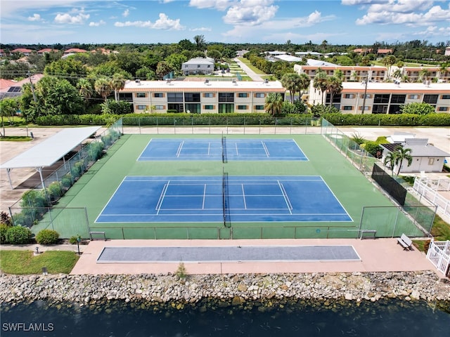 view of sport court with a water view