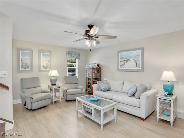 living room featuring ceiling fan and light hardwood / wood-style flooring