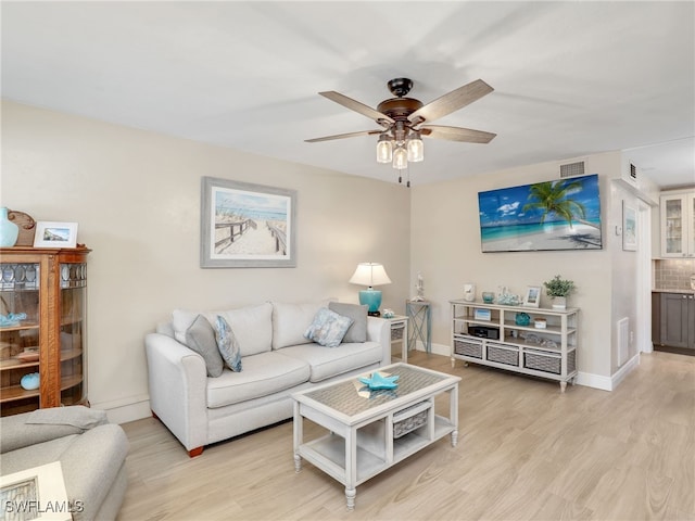 living room with ceiling fan and light hardwood / wood-style floors