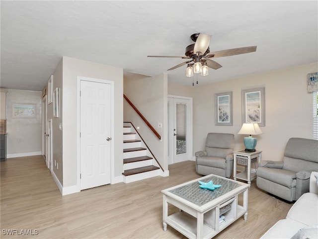 living room featuring light wood-type flooring and ceiling fan