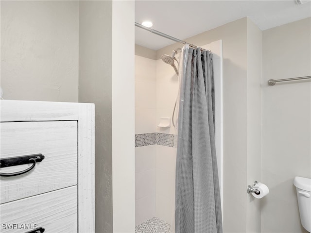 bathroom with toilet and curtained shower