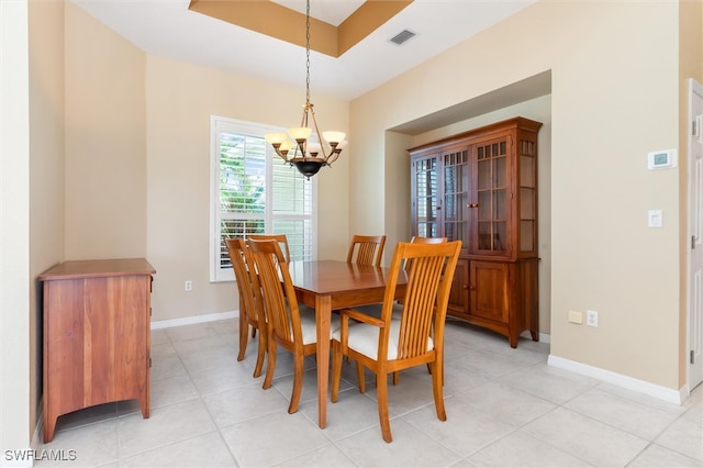 tiled dining area featuring an inviting chandelier