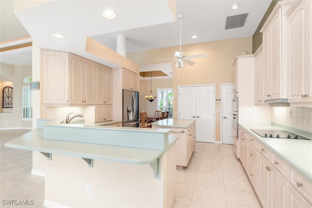 kitchen with backsplash, stainless steel appliances, ceiling fan, and light tile patterned floors