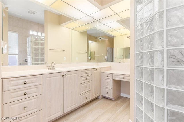 full bathroom with visible vents, a ceiling fan, wood finished floors, walk in shower, and vanity