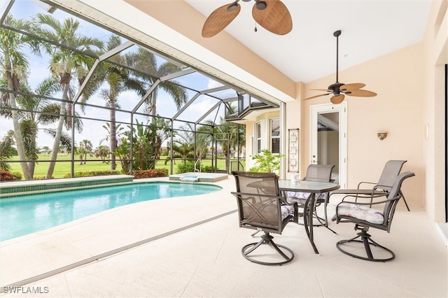 view of swimming pool with glass enclosure, ceiling fan, and a patio