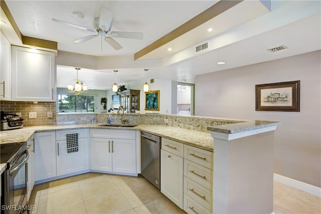 kitchen with white cabinets, ceiling fan with notable chandelier, light stone counters, stainless steel appliances, and kitchen peninsula