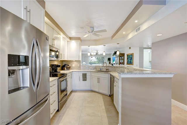 kitchen with ceiling fan with notable chandelier, stainless steel appliances, sink, kitchen peninsula, and white cabinets