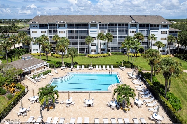 view of pool with a patio area and a lawn