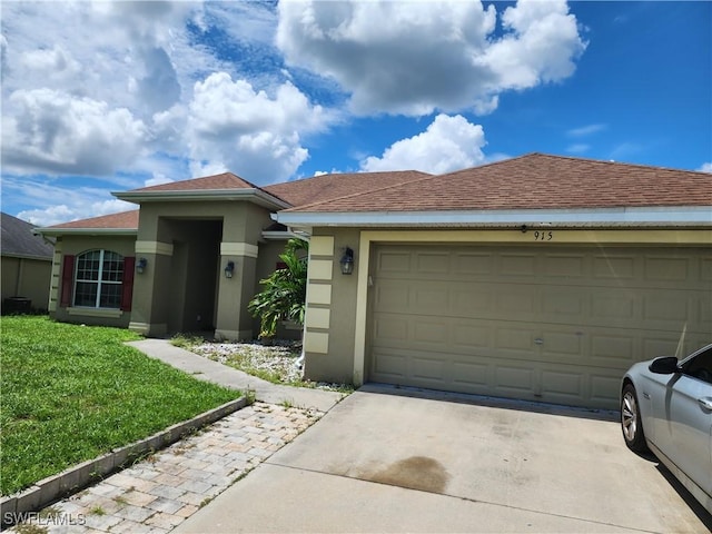 915 Alvin Ave, Lehigh Acres, FL 33971 - view of front of home featuring roof with shingles, driveway, stucco siding, a front lawn, and a garage