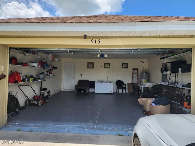 915 Alvin Ave, Lehigh Acres, FL 33971 - garage with refrigerator, washer / clothes dryer, a garage door opener, and water heater