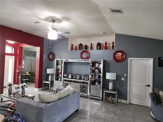 tiled living room with ceiling fan