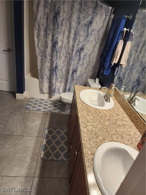 full bathroom featuring tile patterned flooring, toilet, vanity, and shower / bathtub combination with curtain