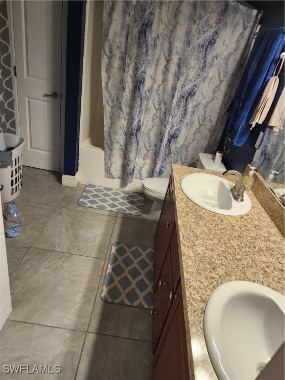 full bathroom with tile patterned flooring, vanity, shower / tub combo, and toilet